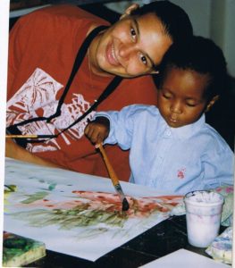 International Sports Psychologist  Caren with a young boy painting